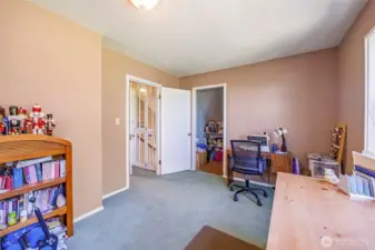 A cozy retreat with a spacious walk-in closet—this bedroom offers a warm and inviting space perfect for rest and relaxation.