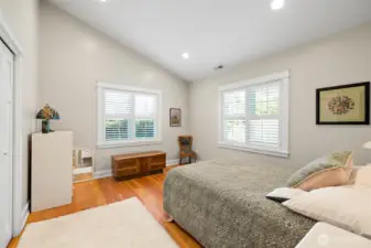 Bedroom two continues with vaulted ceiling and hardwood floors.