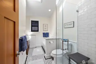 A second full bath continues with updated charm with custom tile throughout.