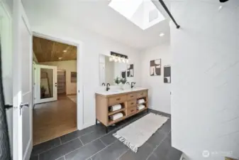 Primary ensuite with double vanity, flooded with light