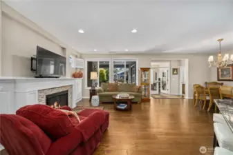 The entry welcomes you to the expansive great room with a beautiful fireplace with custom built-ins, gleaming Engineered hardwoods and large windows overlooking the tranquil backyard.