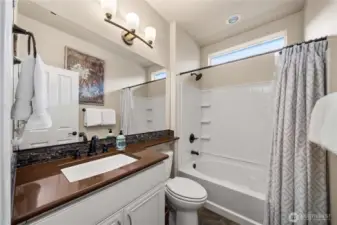 Guest bath/powder room with Quartz counters and tile flooring.