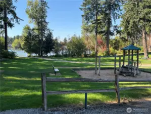 Private playground, with park benches and lush lawn