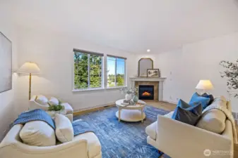 Open main level with gas fireplace, half bath, and covered porch.