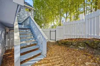 Wonderful covered porch off main level dining area features stairs to the small fenced outdoor space