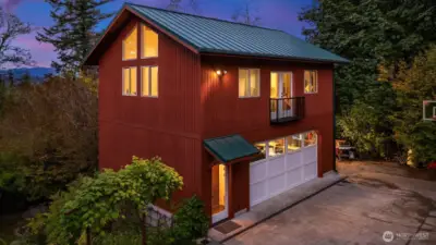 Detached 2 car garage with built in shelving and 562 sf studio apartment above.  If desired, Seller will remove basketball hoop, wood shed and tree and add a gravel pad to extend the driveway
