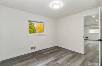 Guest bedroom with a view of the beautiful trees outside