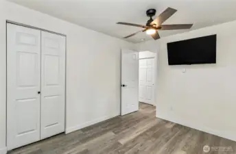 Back corner showing new floors, paint, fan, handles, TV included