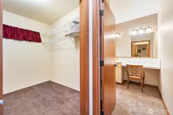 Unit A - Primary bedroom walk in closet and vanity