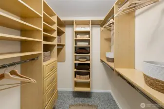 Large walk in closet with custom built ins