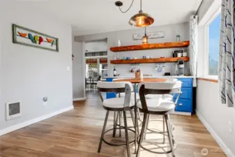 Dining space with beverage/coffee bar and floating shelves.
