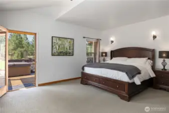 A bright and spacious primary bedroom with easy access to the hot tub—perfect for relaxing.