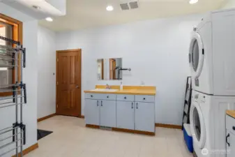 A large utility room with plenty of storage, washer and dryer, and a handy utility sink—practical and organized.