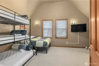 One of the upstairs bedrooms is perfect as a cozy bunk room for family or guests.