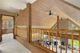 Dramatic open living area with soaring ceilings and charming tongue-and-groove detail.