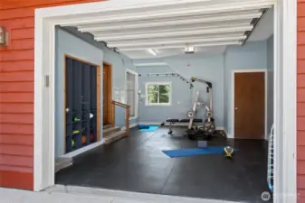 The attached garage has been transformed into a fully equipped gym for convenient workouts at home.