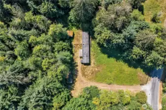 This mostly cleared acre is not in open space, & has a well, power & septic system.