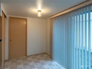 Eating area in kitchen, with pantry on other side of the room.