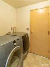 Laundry room with furnace across the room.