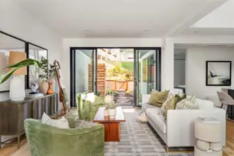 The spacious living room provides access to both the front patio and back garden through large sliding glass doors, creating a seamless indoor-outdoor flow that enhances the sense of space and natural light.