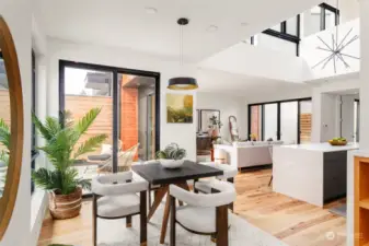 The dining space is bathed in natural light and seamlessly connects to the outdoors, offering the perfect setting for indoor-outdoor living.