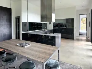 View from dining area to kitchen and primary bedroom door