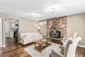 One of two living areas features beautiful natural light and a class Kodiak wood burning stove