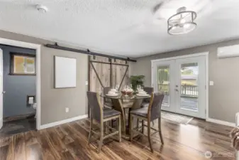 Open living space offers flexibility while custom barn doors enclose washer and dryer