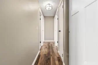 Hallway leading to the bedrooms offer multiple closets for storage