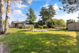 There are so many areas in this backyard to enjoy! Firepit area, storage shed, garden space, chicken coop, entertaining deck, etc