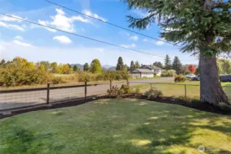 Fenced front yard offers mountain view