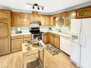 Close up of kitchen.  Laminate flooring and plenty of cabinets.