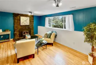 Rec/family room features second fireplace with insert.  Laminate flooring and large windows bring in plenty of light.