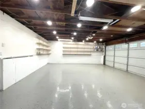 Ample garage with updated lighting and separate electrical panel.  EV ready, lots of shelving with access to rear yard. Perfect for shop/art studio.