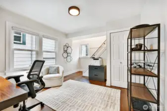 Spacious main floor den/office/flex space. Currently used as an office with stairs connecting to Primary bedroom on 2nd floor. Hardwood floor, closet and double pane windows.