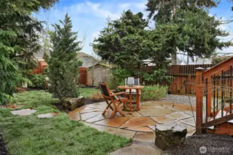 Peaceful, landscaped and fully fenced backyard with lovely flagstone patio.