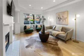 Main floor features open-concept kitchen and living area with abundant natural light, cozy gas fireplace, and powder room.