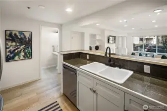 All right, we're back inside the unit from the garage. Access to the garage is through the door which is out of the frame in this photo to the left. But in the center of this shot is the open door to the half bath on this level.