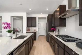 Beautiful oversized kitchen with whirpool stainelss steel appliances and quartz countertops.