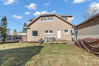 Large fenced yard with fruit trees and deck