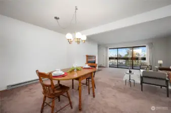 As you enter this top floor condo open living and dining area with fireplace and balcony access. Living area staged virtually