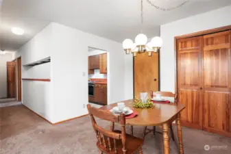 looking toward entry door, kitchen and hallway to bedrooms and bath.Laundry in closet at end of hallway