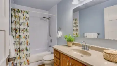 Another bathroom featuring a tub, likely the second bathroom in the home.