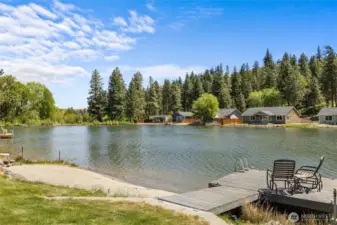 Expansive backyard with lush lawn, waterfront views, and space to relax or entertain.