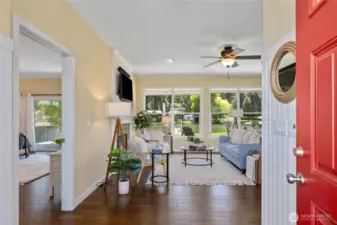 The front entryway boasts expansive windows, allowing natural light to fill the space. The open layout seamlessly transitions into the rest of the home, offering a perfect blend of functionality and style.