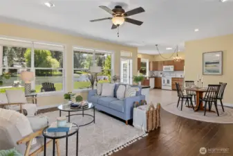 Spacious and sunlit living room with large windows that fill the space with natural light. The open floor plan is perfect for entertaining or relaxing with family.