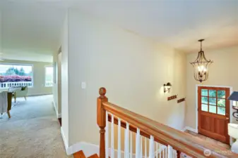 Top of stairs looking into living room and view.