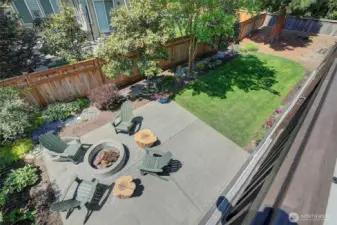Deck overlooks landscaped level backyard
