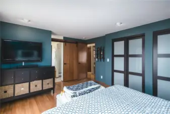 Another view of the primary bedroom with custom paint and closet doors and cute barn doors!