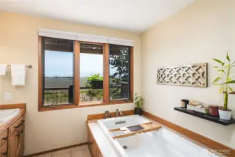 Spa-like primary ensuite with soaking tub, double sink vanity and walk-in shower. Enjoy gorgeous mountain and farmland views as you relax!